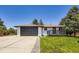 Charming exterior with a two-car garage and well-maintained lawn and inviting front porch at 4475 S Routt St, Littleton, CO 80127