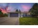 Charming exterior with a two-car garage and well-maintained lawn, taken at twilight at 4475 S Routt St, Littleton, CO 80127