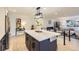 Modern kitchen featuring a large island, pendant lighting, and stainless steel appliances at 4475 S Routt St, Littleton, CO 80127