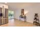 Bright living area with stainless refrigerator and view of porch through sliding glass door at 4475 S Routt St, Littleton, CO 80127
