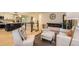 Open-concept living area featuring a modern fireplace and seamless transition to the kitchen at 4475 S Routt St, Littleton, CO 80127