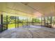 Large, covered patio with concrete flooring and seating area overlooking the yard at 4475 S Routt St, Littleton, CO 80127
