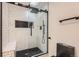 Chic bathroom features a glass-door shower with black hardware and contrasting white tile at 4475 S Routt St, Littleton, CO 80127