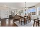 Bright living area with hardwood floors, natural light, and an open layout to the dining room and entry at 6480 S Newcastle Way, Aurora, CO 80016