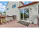 Outdoor deck with a view of the home exterior and glass sliding door at 1005 S Lewiston Way, Aurora, CO 80017