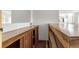 Stylish home bar with wooden counters, shelving, and storage, perfect for entertaining guests at 1005 S Lewiston Way, Aurora, CO 80017