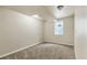 This finished basement area features plush carpeting and a window for natural light at 1005 S Lewiston Way, Aurora, CO 80017