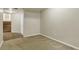 Spacious basement area with plush carpeting, and access to stairs and storage closet at 1005 S Lewiston Way, Aurora, CO 80017