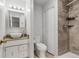 Updated bathroom featuring vanity sink and decorative tiled shower and tub at 1005 S Lewiston Way, Aurora, CO 80017