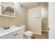 Bathroom featuring a white vanity, toilet, tile flooring and large mirror at 1005 S Lewiston Way, Aurora, CO 80017