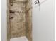 Shower featuring tiled surround with decorative detail and built in storage at 1005 S Lewiston Way, Aurora, CO 80017