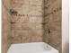 Updated bathroom featuring decorative tile surround in the bathtub and shower area at 1005 S Lewiston Way, Aurora, CO 80017