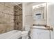 Updated bathroom features decorative tile surround in the bathtub/shower, and vanity with sink at 1005 S Lewiston Way, Aurora, CO 80017