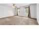 Large primary bedroom with two windows offering plenty of natural light and neutral colored carpet at 1005 S Lewiston Way, Aurora, CO 80017