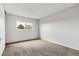 Bedroom featuring neutral carpet and a large window for natural light at 1005 S Lewiston Way, Aurora, CO 80017