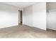 Bedroom features neutral carpet, white walls and trim and closet with sliding doors at 1005 S Lewiston Way, Aurora, CO 80017