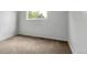 Inviting bedroom with a large window providing natural light and cozy carpeting at 1005 S Lewiston Way, Aurora, CO 80017