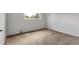 This cozy bedroom features neutral walls, plush carpeting, and a sunlit window at 1005 S Lewiston Way, Aurora, CO 80017