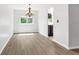 Bright dining room featuring hardwood floors, a modern chandelier, and natural light at 1005 S Lewiston Way, Aurora, CO 80017
