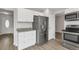Modern kitchen showcasing stainless steel appliances, granite countertops, and white cabinetry at 1005 S Lewiston Way, Aurora, CO 80017