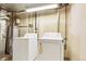 A well-lit laundry area features a newer washer and dryer set for convenient home chores at 1005 S Lewiston Way, Aurora, CO 80017