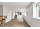 Spacious living area with natural light, stairs to a loft, bar seating, and neutral carpet at 1005 S Lewiston Way, Aurora, CO 80017