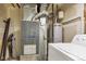 Utility room showcasing the furnace and water heater, essential home systems at 1005 S Lewiston Way, Aurora, CO 80017