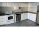 Modern kitchen featuring white cabinets, granite countertops, and stainless steel appliances at 2678 S Xanadu Way # C, Aurora, CO 80014