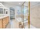 Bright bathroom featuring double vanity, soaking tub, glass-enclosed shower and neutral finishes at 7193 S Versailles Way, Aurora, CO 80016