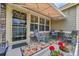 Cozy front porch with awning, seating area, and colorful outdoor rug, perfect for relaxing at 7193 S Versailles Way, Aurora, CO 80016