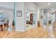 Hallway features hardwood floors and views of office and entryway at 7193 S Versailles Way, Aurora, CO 80016