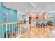Inviting hallway with hardwood floors leading to an open-concept kitchen at 7193 S Versailles Way, Aurora, CO 80016