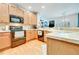 Kitchen features stainless steel appliances, light wood cabinets, and an open layout at 7193 S Versailles Way, Aurora, CO 80016