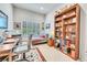 Cozy office space with built-in shelves and comfortable seating at 7193 S Versailles Way, Aurora, CO 80016