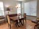 Inviting dining room with hardwood floors, a wooden table, and bright natural lighting from large windows at 10634 Ashfield St, Highlands Ranch, CO 80126