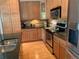 Updated kitchen featuring wood cabinets, granite counters, stainless steel appliances, and tile backsplash at 10634 Ashfield St, Highlands Ranch, CO 80126