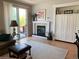 Cozy living room with a fireplace, built-in shelving, and sliding door access to the patio at 10634 Ashfield St, Highlands Ranch, CO 80126