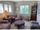 Cozy living room featuring plush seating, natural light from large windows, and a charming traditional-style cabinet at 10634 Ashfield St, Highlands Ranch, CO 80126