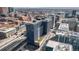 Modern high-rise with rooftop green space, train tracks, and surrounding urban landscape at 1750 Wewatta St # 728, Denver, CO 80202