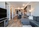 Open living room and kitchen area with hardwood floors at 1750 Wewatta St # 728, Denver, CO 80202