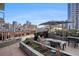 Outdoor patio area with comfortable seating, plants, and city skyline views at 1750 Wewatta St # 728, Denver, CO 80202
