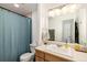 Bathroom featuring a blue shower curtain, oak cabinets and a white sink at 100 Now Colorado Ct # D1, Breckenridge, CO 80424