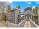 Condominium exterior with private outdoor decks and a walkway, surrounded by mature trees at 100 Now Colorado Ct # D1, Breckenridge, CO 80424