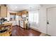 Bright kitchen features wood cabinets, a white refrigerator, and hardwood floors at 100 Now Colorado Ct # D1, Breckenridge, CO 80424