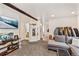 Open living room with large TV and view of the bathroom and laundry room at 100 Now Colorado Ct # D1, Breckenridge, CO 80424