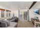 Inviting living room featuring a comfortable gray sectional sofa, carpet, and a sliding door to the deck at 100 Now Colorado Ct # D1, Breckenridge, CO 80424