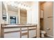 Bathroom featuring a double vanity, neutral color scheme, and large mirror at 7432 S Quail Cir # 1818, Littleton, CO 80127