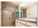 Bathroom features walk-in shower with seat, vanity with a white sink and light-colored cabinets at 7432 S Quail Cir # 1818, Littleton, CO 80127