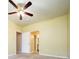 Bedroom with warm-toned walls, neutral carpet, and access to the ensuite bathroom at 7432 S Quail Cir # 1818, Littleton, CO 80127