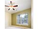 Bedroom featuring neutral carpet, a ceiling fan, and a large window at 7432 S Quail Cir # 1818, Littleton, CO 80127